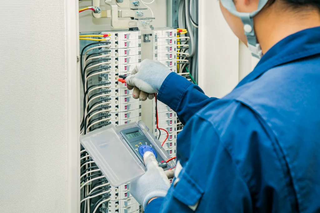 Electrician checking a building control panel