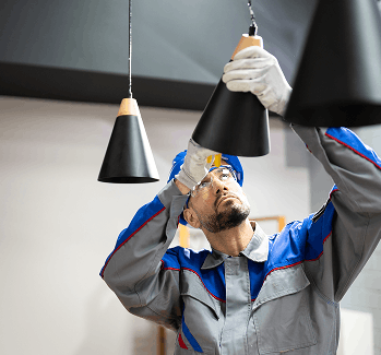 Electrician installing pendant light fixtures